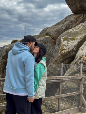 Couple Embracing with Scenic Mountain Viewの写真素材
