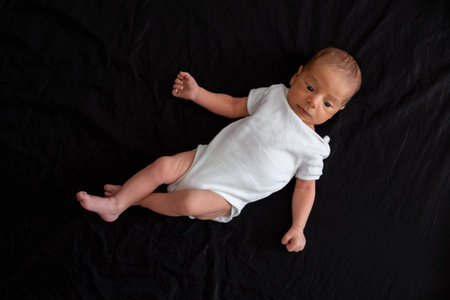 Newborn Baby on Black Backgroundの写真素材