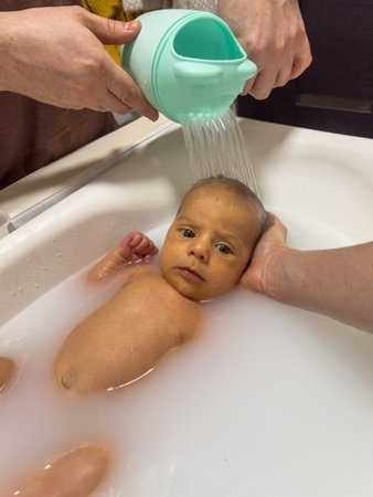 Newborn Baby Bathtime in little bathの写真素材