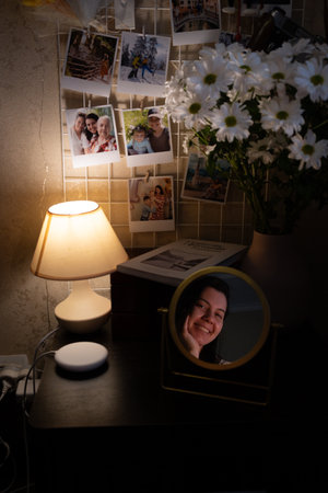 Cozy Bedroom Corner with Lamp and Photosの写真素材