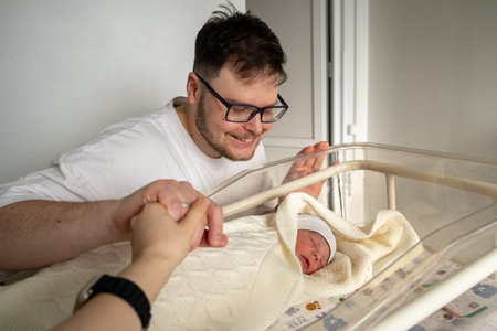 Father Adoring His Newborn Baby in Hospitalの写真素材