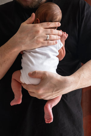 Man Holding Newborn Baby in Tender Moment