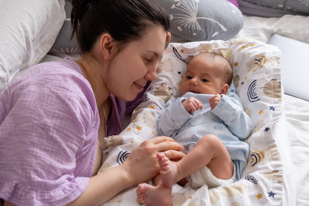 Mother and Baby Relaxing Together on Bed