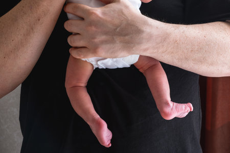 Man Holding Newborn Baby in Tender Moment