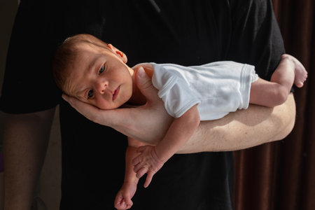 Newborn Baby Cradled in Handの写真素材