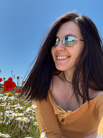 Woman Relaxing in a Field of Wildflowersの写真素材