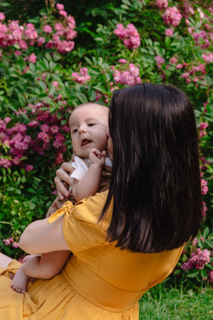 Joyful Mother and Baby in Blooming Garden