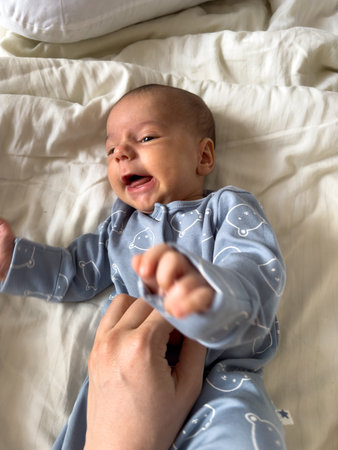 Baby in Blue Onesie with Bear Patternの写真素材