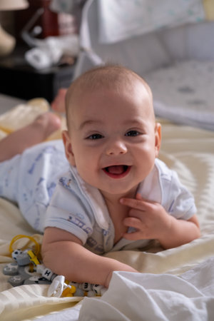 Happy Baby Playing with Toys on a Blanketの写真素材