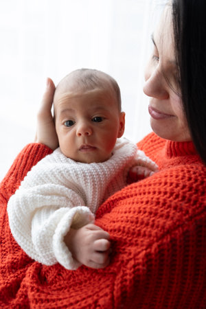 Tender Moment Between Mother and Baby by the Window