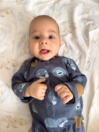 Baby in Blue Onesie with Animal Printsの写真素材