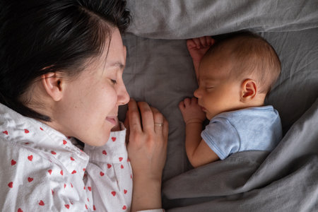 Mother and Baby Sleeping Peacefully Togetherの写真素材