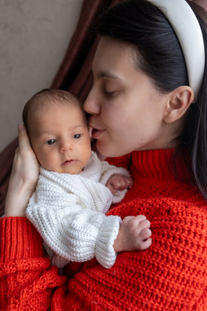 Tender Moment Between Mother and Baby by the Windowの写真素材
