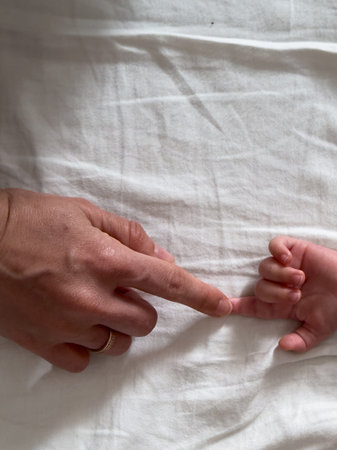 Adult and Baby Hand Connectionの写真素材