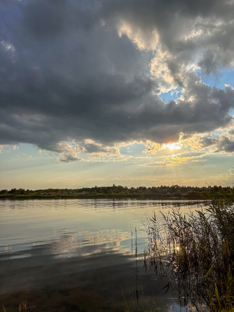 Serene Sunset Reflection Over a Tranquil Lakeの写真素材