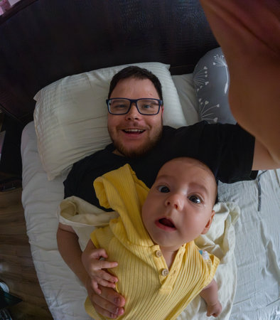 Father and Baby Selfie on Bed