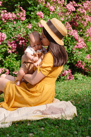 Joyful Mother and Baby in Blooming Garden