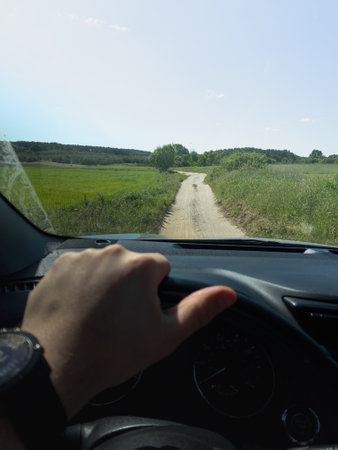 Driving on a Scenic Rural Dirt Roadの写真素材