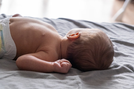 Newborn Baby Resting on Bed
