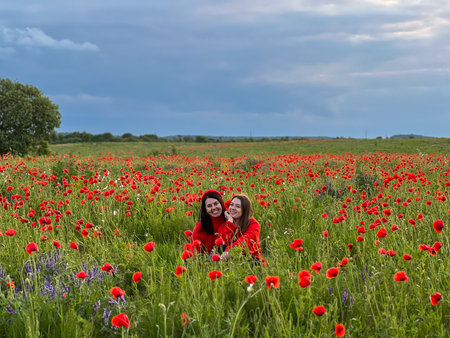 Women in Red in a Poppy Fieldの写真素材