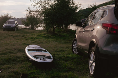 Lakeside Adventure with SUV and Paddleboardの写真素材