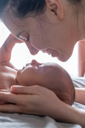 Tender Moment Between Mother and Newbornの写真素材