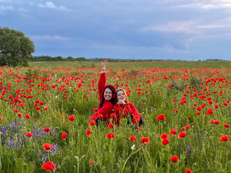 Women in Red in a Poppy Fieldの写真素材