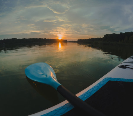 Sunset Paddleboarding on a Tranquil Lake