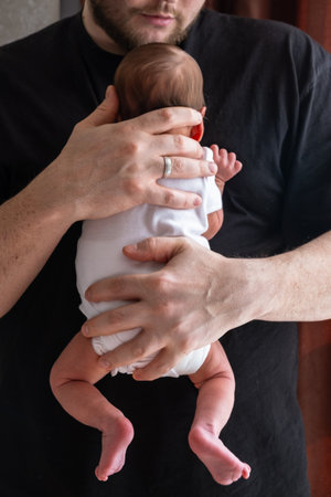 Man Holding Newborn Baby in Tender Moment