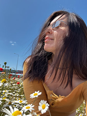 Woman Relaxing in a Field of Wildflowersの写真素材