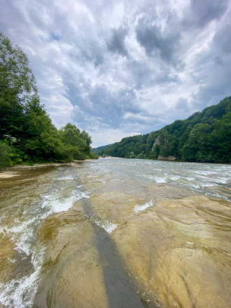 Serene River Flowing Through Lush Forest