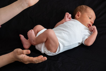 Newborn Baby on Black Backgroundの写真素材