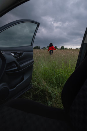 Person in Red Jacket Standing in Field