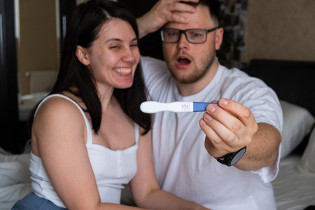 Happy Couple Celebrating Positive Pregnancy Testの写真素材