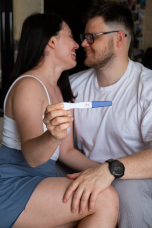 Happy Couple Celebrating Positive Pregnancy Test