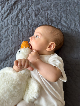 Baby Smiling with Plush Duck Toy