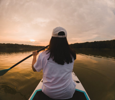 Paddleboarding at Sunset on a Calm Lake