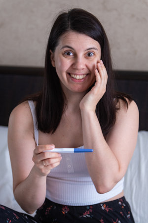 Surprised Woman with Positive Pregnancy Test
