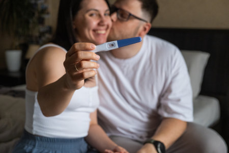 Happy Couple Celebrating Positive Pregnancy Testの写真素材