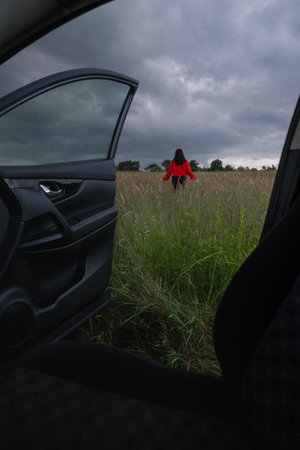 Person in Red Jacket Standing in Fieldの写真素材
