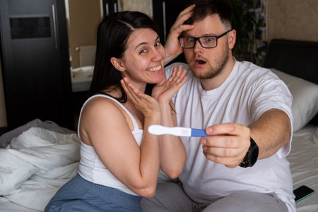 Happy Couple Celebrating Positive Pregnancy Testの写真素材