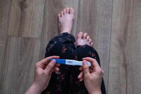 Positive Pregnancy Test in Hand