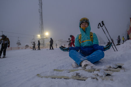 Skier Resting on Snowy Slope at Ski Resortの写真素材