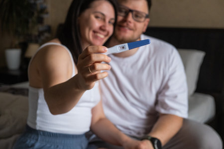 Happy Couple Celebrating Positive Pregnancy Test