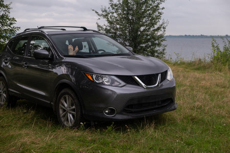 Feet visible in a parked car by the lakeの写真素材