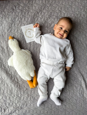 Joyful Baby with Plush Duck and Milestone Card