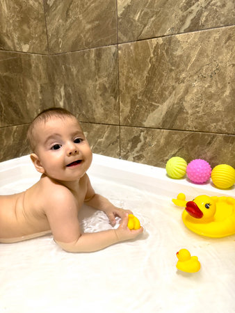 Baby Playing with Rubber Ducks in Bathtub