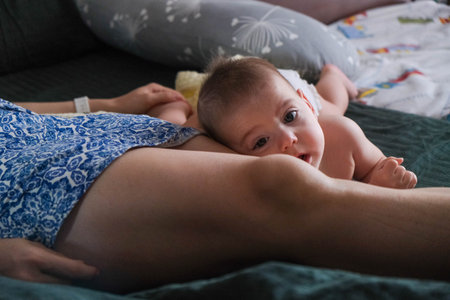 Baby resting on parents leg in cozy setting