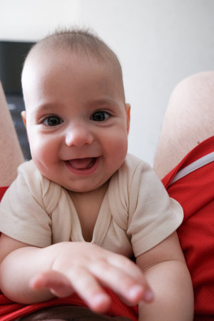 Adorable Baby Close-Up with Red Shorts Background