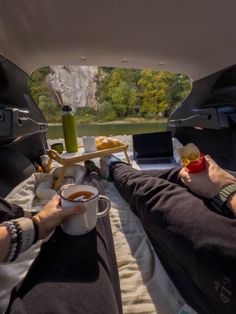 Cozy Car Camping with Scenic River Viewの写真素材